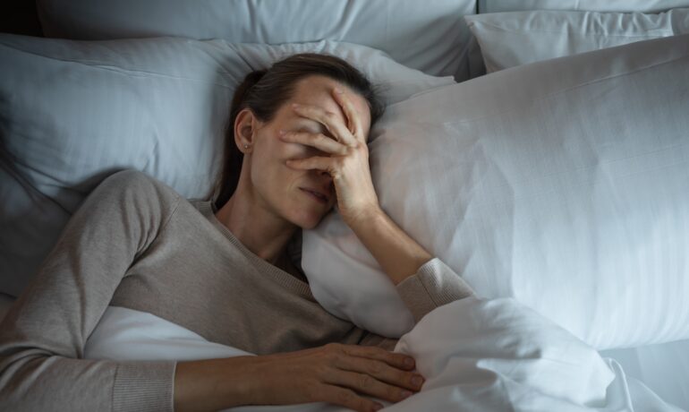 Woman with fibromyalgia struggling to sleep at night.