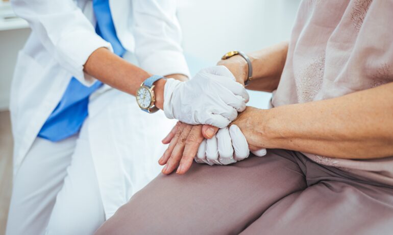 Nurse holding patients hand.